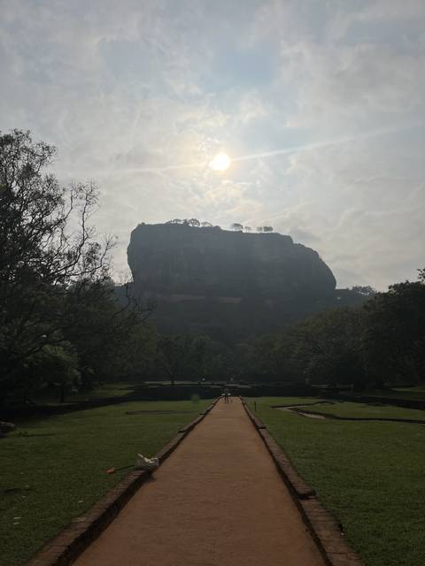 Distant view of a rocky outcrop under the sun.