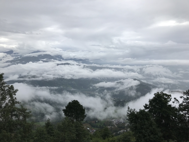 Mountainous region covered with clouds in a mystical setting.
