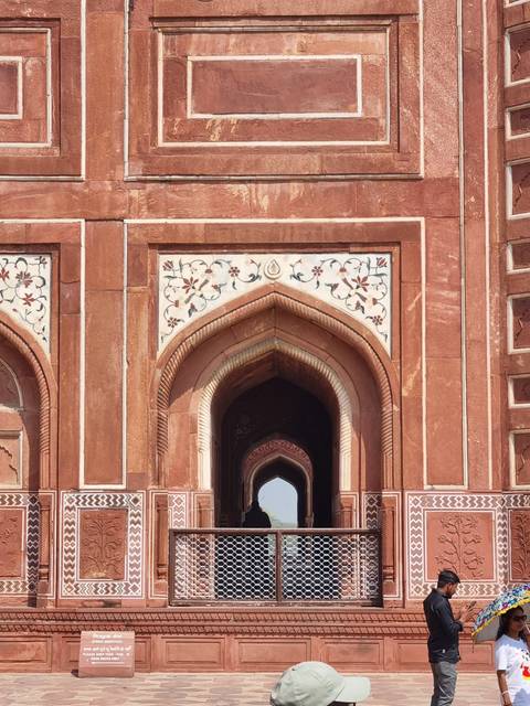 Red sandstone structure with intricate designs.
