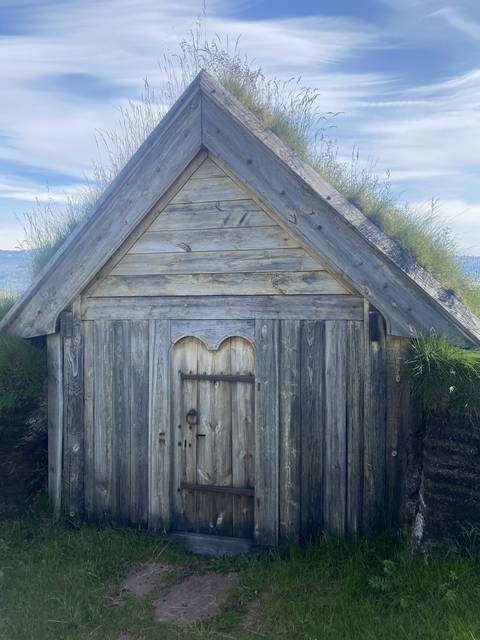 Traditional wooden structure with grass on top.