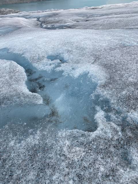       Close-up view of an ice surface with blue ice visible.
  