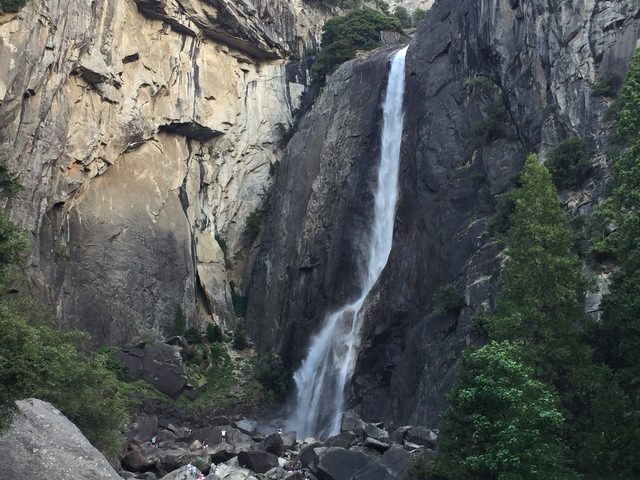 Tall waterfall descending down a steep rock face