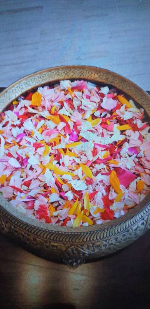 Colorful petals in a decorative bowl.