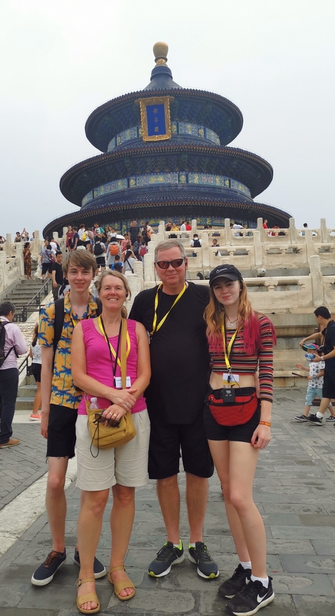 Family photo at the Temple of Heaven among a crowd.