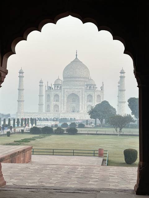       View of Taj Mahal through an archway.
  