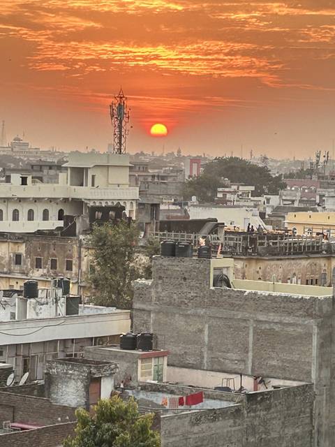       Sunset view over a cityscape with a red sky.
  