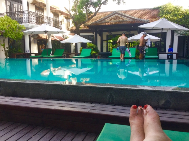       Poolside view with loungers and people in swimwear
  