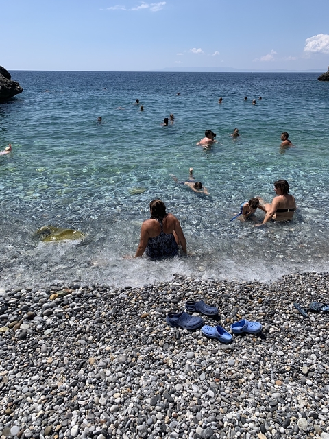 People enjoying the sea on a pebble beach