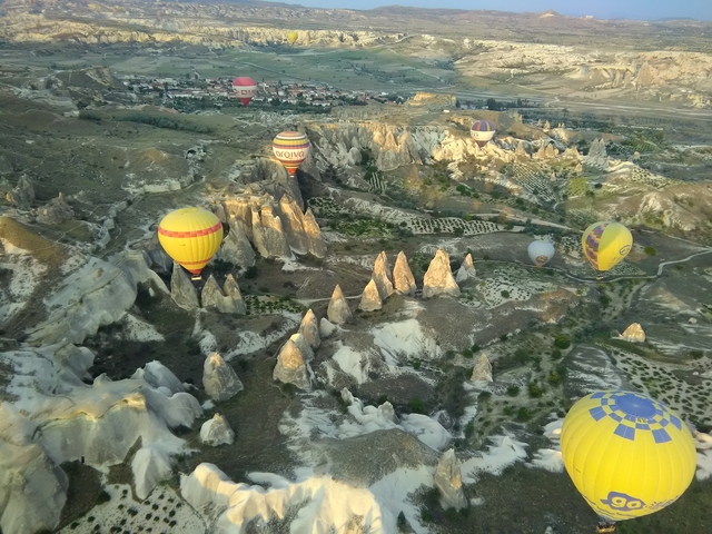 Hot air balloons flying over unique rock formations