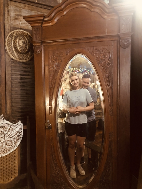       Two people standing in front of a mirror.
  