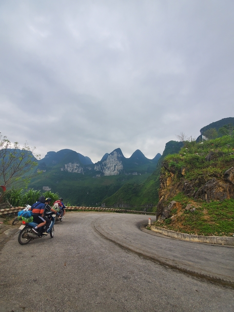       Group of travelers on a scenic mountain road.
  