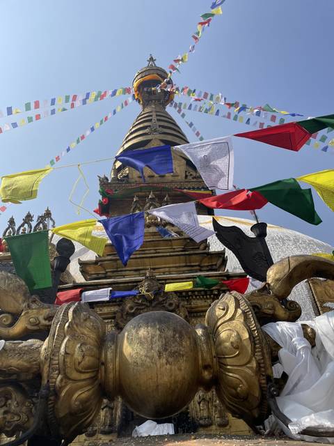       Colorful flags on a stupa during the day.
  