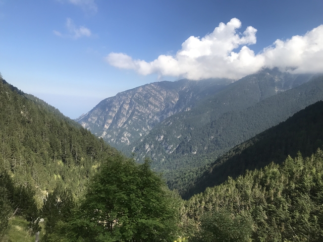 View of mountainous landscape with clouds touching the peaks.