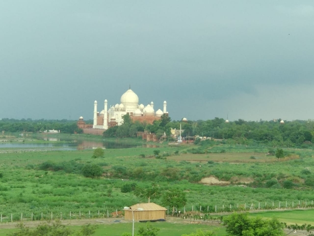 A distant view of the Taj Mahal from across the river.