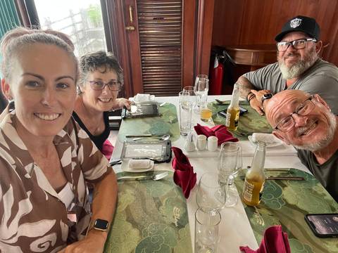 Group photo at a dining table.