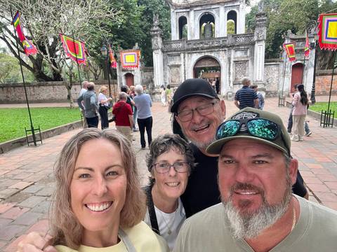 Group at a historic site with arches and a stone path.