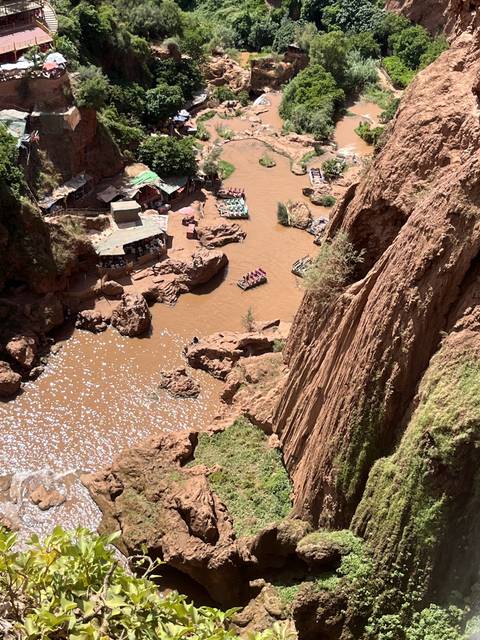       View of rocky terrain with water below.
  