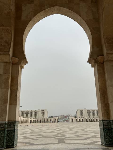       Large archway overlooking a city plaza.
  