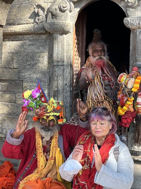 Unique individuals in traditional attire posing for a photo.