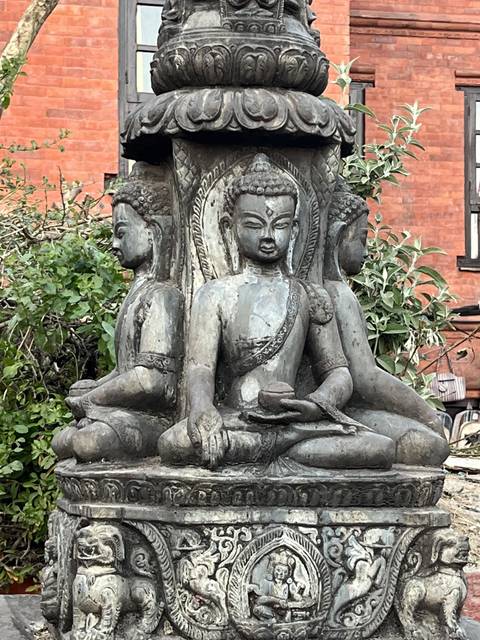 Stone carvings of deities on a monument.