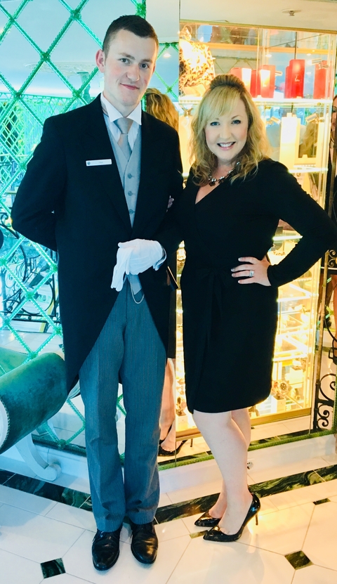 People dressed elegantly inside a decorated building.