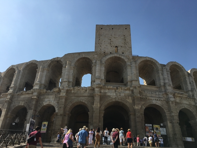 Roman amphitheater under a clear blue sky.