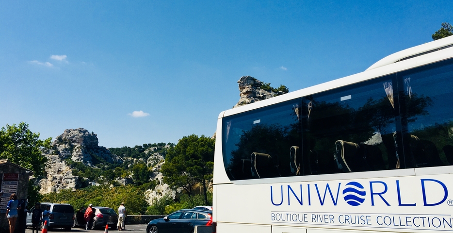 Tour bus with a rocky landscape in the background.