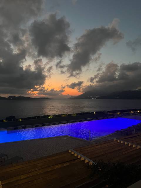      Infinity pool overlooking the sea at sunset.
  
