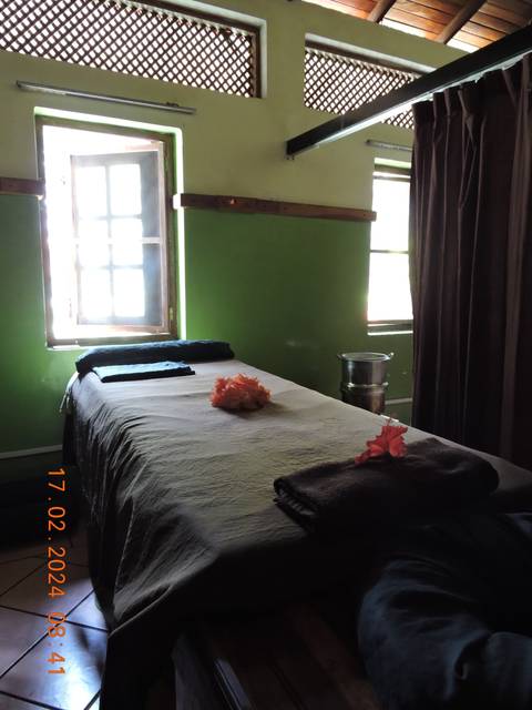 Spa room with a massage table and decor