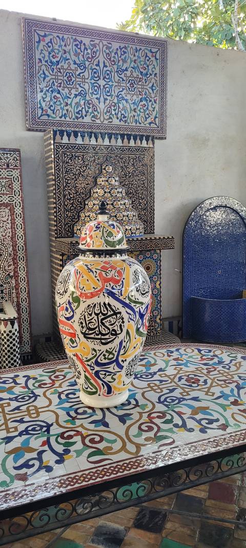 Colorful pottery and tiles displayed on a wall.