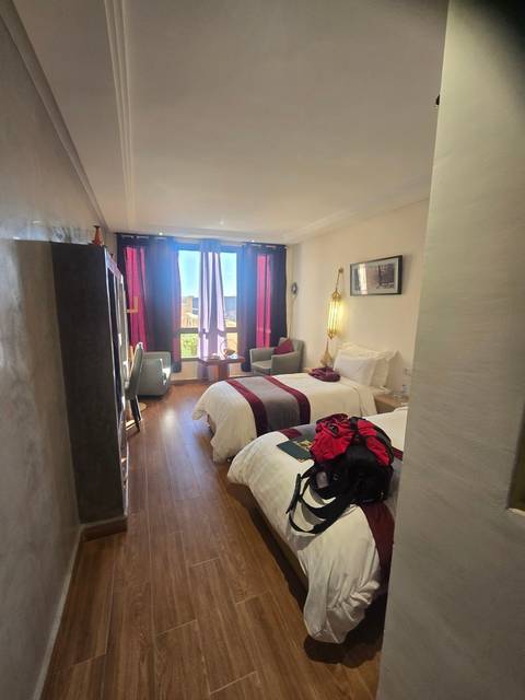 Neatly made hotel room with modern decor.