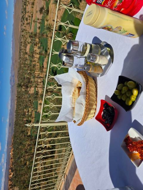 Breakfast setup with bread, condiments, and a scenic view.
