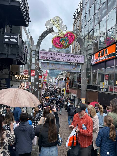 Busy city street filled with people and colorful signage.