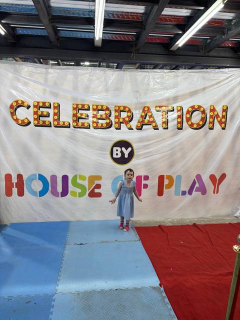 Child posing in front of a colorful backdrop.