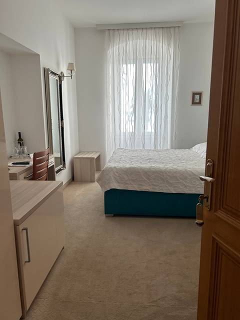       Interior of an accommodation with a bed and window.
  