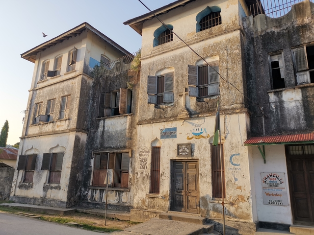 An old building with worn paintwork and architectural details.