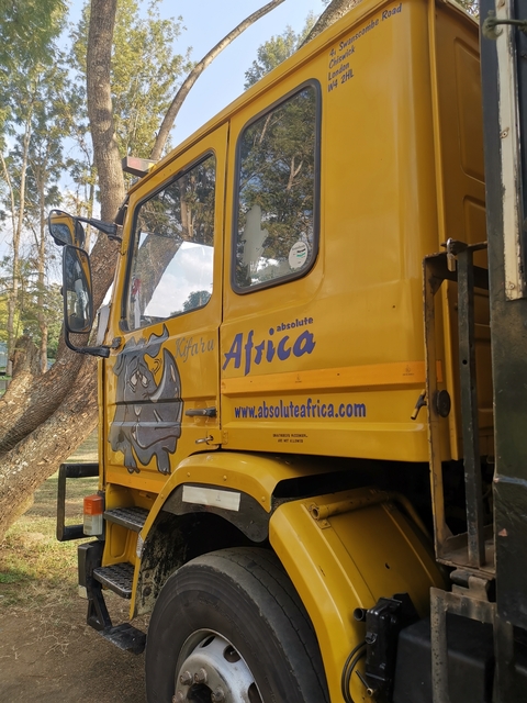 Side of a yellow truck with 'Africa' written on it.