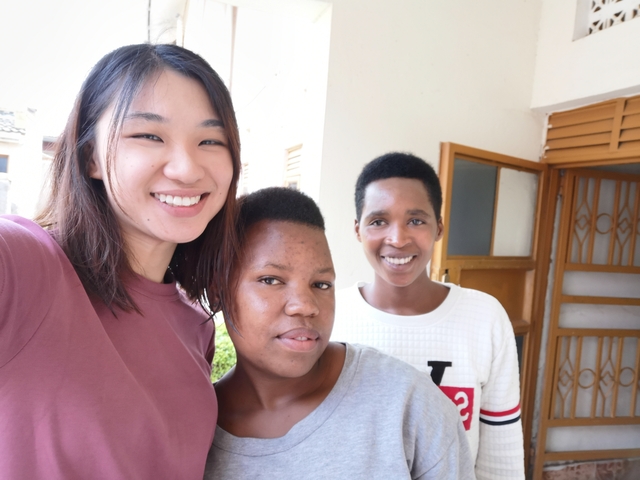       Three smiling women posing for a selfie indoors.
  