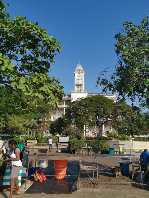       A historic clock tower surrounded by greenery.
  