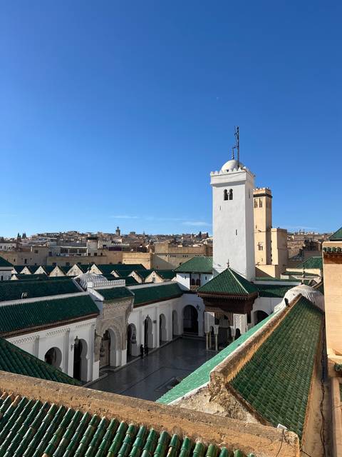 Aerial view of a city with traditional architecture and a tower.