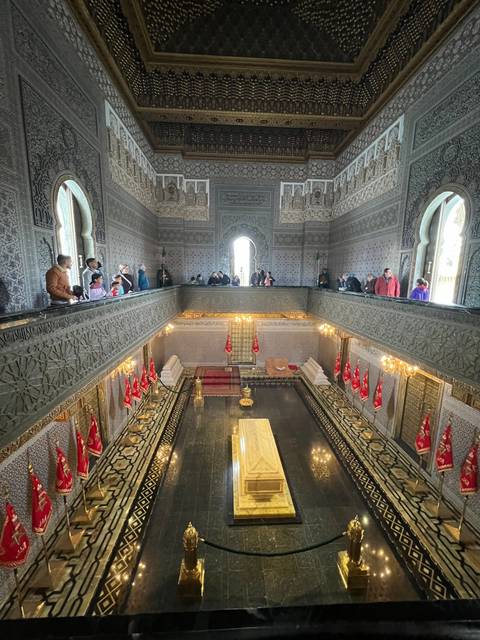Interior view of a mausoleum with visitors.