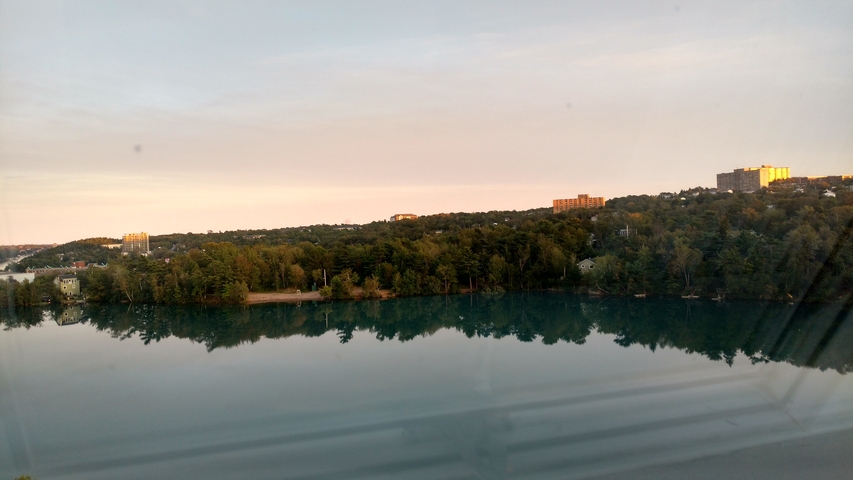       View of a lake with buildings in the distance.
  