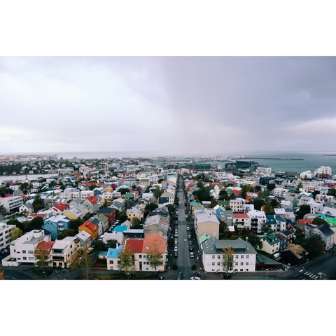 Panoramic view of colorful city buildings and harbor.