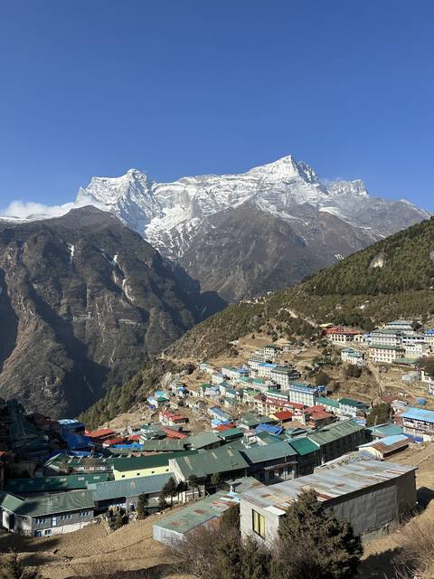       Elevated view of a village nestled in the mountains.
  