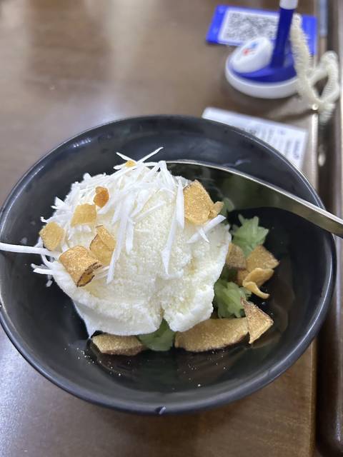 Dessert dish with ice cream and toppings.