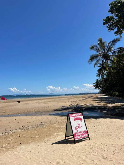 Warning sign on a sandy beach.