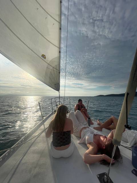 People lounging on a sailboat.