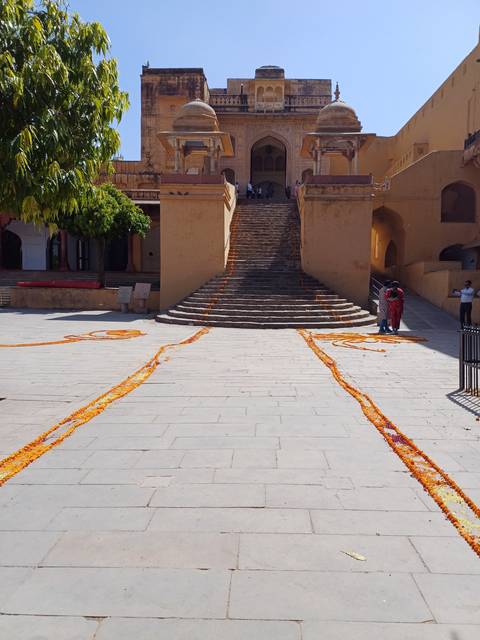Entrance of a historic fort with marigold decorations.