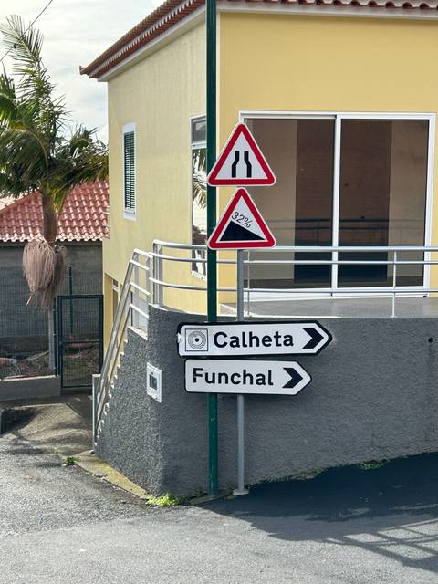 Road signs pointing to Calheta and Funchal.