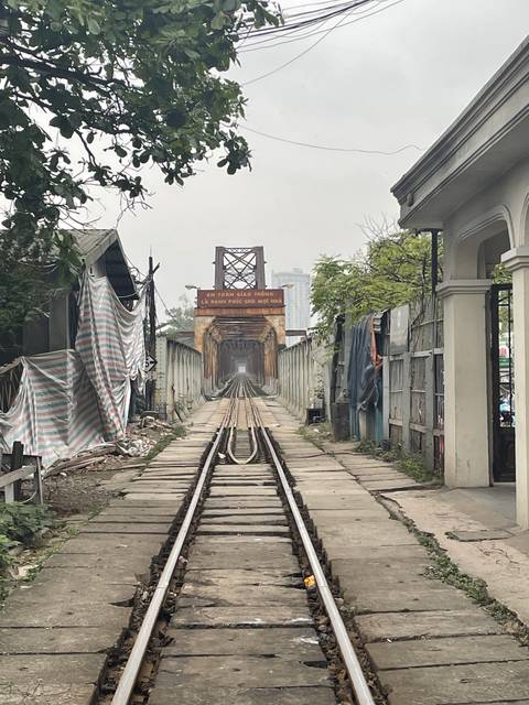 A railway track leading into the distance under overcast skies.